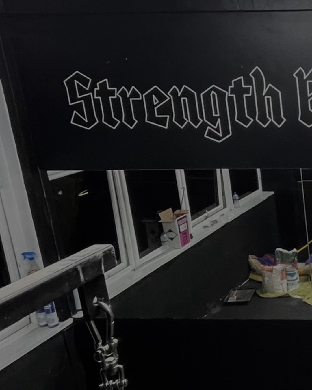 Blackletter wall lettering reading Strength